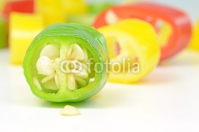 A macro image of a sliced green chilli pepper