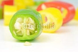 Naklejki A macro image of a sliced green chilli pepper