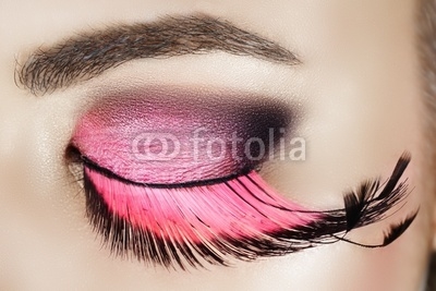 Macro eye of a woman with pink smoky eyeshadow