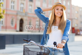Naklejki Young stylish woman in a city street