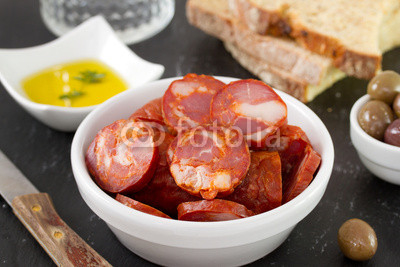 chorizo in bowl with oil and bread