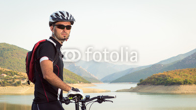 Mountain biker beside a beautiful lake