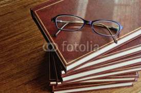 stack of books and glasses top view