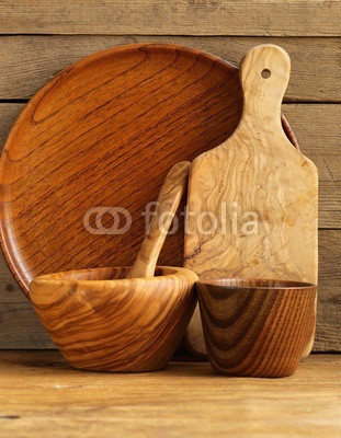 set of wooden organic utensils on natural wooden background