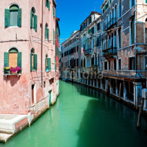Fototapety Beautiful venice canal with houses standing in water, Italy