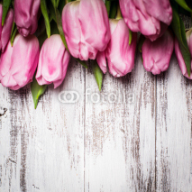 Naklejki Pink tulips over wooden table