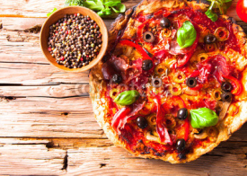 Naklejki Fresh delicious italian pizza served on wooden table.
