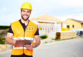 Fototapety Young smiling builder writes on a black folder