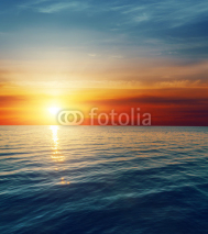 Naklejki Zachód słońca nad taflą ciemnej wody