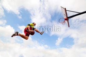 Fototapety Young man making a slam dunk playing streetball basketball