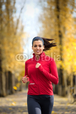 Female athlete running in autumn