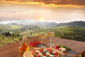 Italian pizza and glasses of white wine in Chianti, Italy
