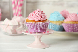 Fototapety Delicious cupcakes on table on light background
