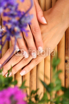 Naklejki Woman in a nail salon receiving a manicure