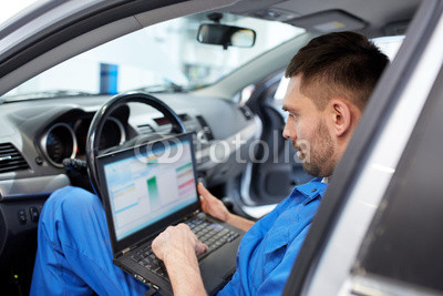 mechanic man with laptop making car diagnostic