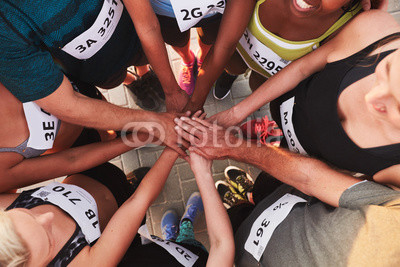 Team with hands together after competition