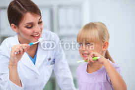 Naklejki Dentist and little girl in the dentist office.