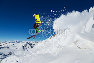 Alpine skier jumping from hill