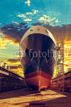 Fototapety Ship in dry dock at sunrise - shipyard in Gdansk, Poland.