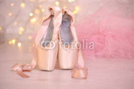 Fototapety Ballet pointe shoes on floor on bokeh background