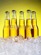 Naklejki Glass of beer with foam on yellow background