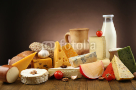 Fototapety Tasty dairy products on wooden table, on dark background