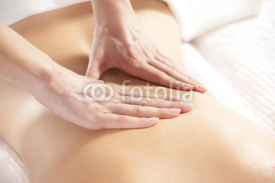 Naklejki woman giving back massage to a girl