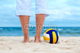 Naklejki ball is lying on sand near sea