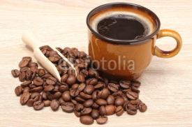 Naklejki Heap of coffee grains and cup of beverage