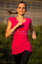 Naklejki Preety young woman running on a track