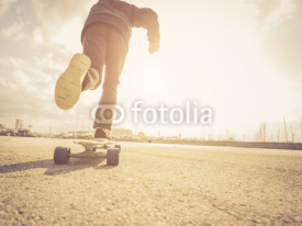 Fototapety Cool street skateboarder in a urban scene.  