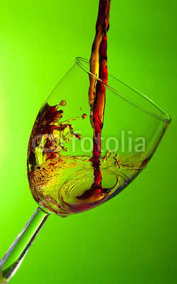 Glass of wine, splash of red wine