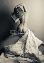 Naklejki Blonde naked in bed on a gray background.