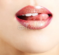 Naklejki Woman licks her lips with tongue