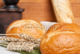 Naklejki Freshly baked traditional rolls with ears of wheat grain