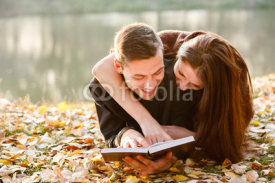 young couple lying down reading