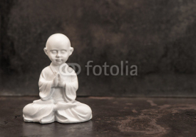 Praying buddha. White statue. Meditation concept