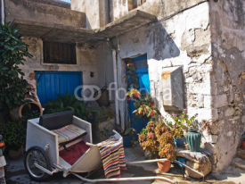 Naklejki Courtyard village of Crete with utensils