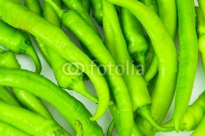 Green peppers in the  plate isolated on white