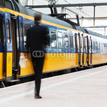 Fototapety Geschäftsmann in Bewegungsunschärfe auf dem Bahnsteig