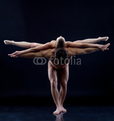Image of two naked acrobats showing trick