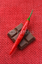 Naklejki Delicious chocolate and red hot chili on a wicker background.