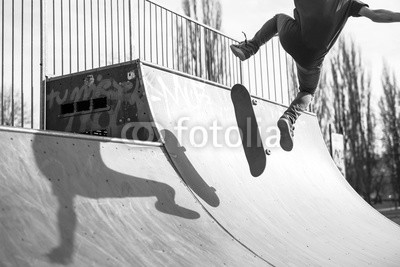 Skater doing a kickflip trick on ramp
