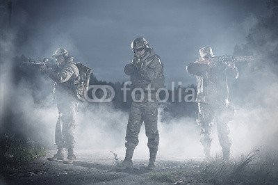 NATO soldiers in full gear. In a defensive posture. Preparing to attack.