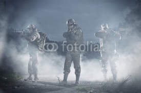 Naklejki NATO soldiers in full gear. In a defensive posture. Preparing to attack.