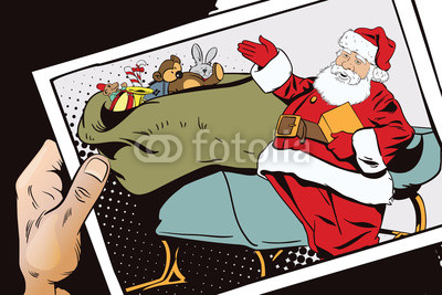 Santa Claus near magical sleigh. Hand with photo.