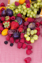 Fototapety tasty summer fruits on a red tablecloth
