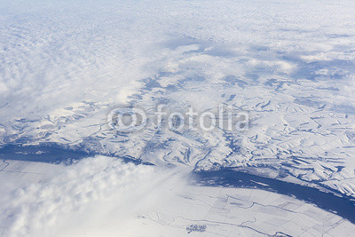 Flying above mountains: snow below