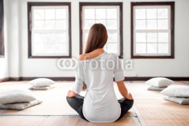 Fototapety Woman practicing yoga indoors