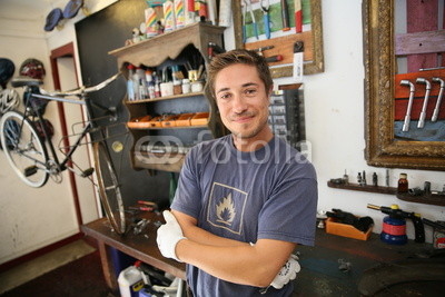 Portrait of smiling business owner in bicycle shop